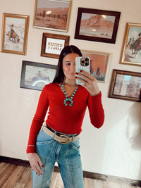 Red Sloan Top by Western Vogue Boutique, featuring a stylish women's tops design with a fitted silhouette and V-neck neckline.