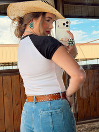 Western Vogue Boutique Spurs Women's T-Shirt, casual top with Western-inspired design and comfortable fit, pictured on model.