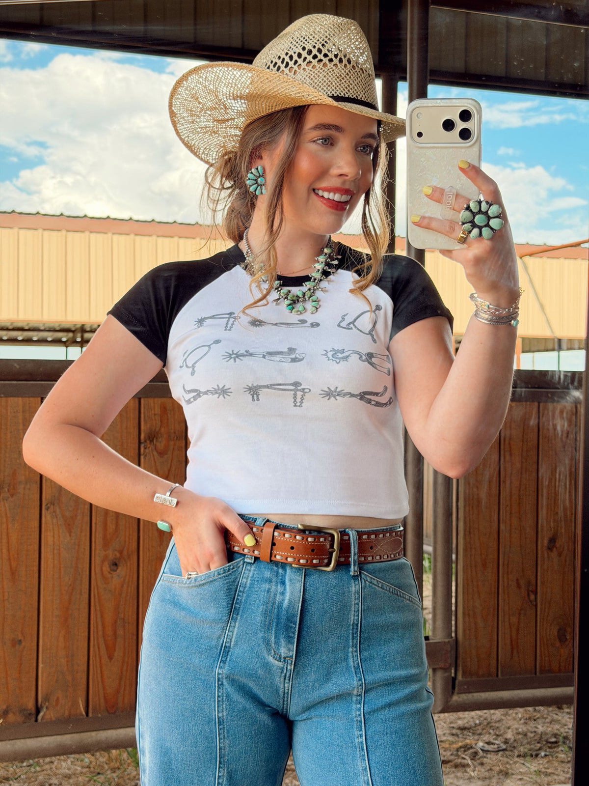 Western Vogue Boutique women's Spurs T-shirt, casual top with western-inspired design and comfortable fit, shown on a model.