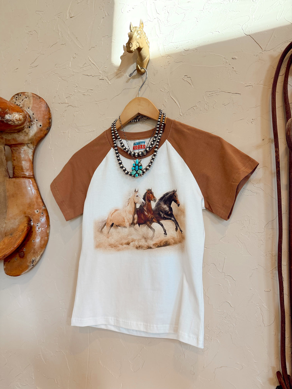 Western Vogue Boutique The Stampede Horses T-Shirt, casual top featuring a horse design on soft fabric.