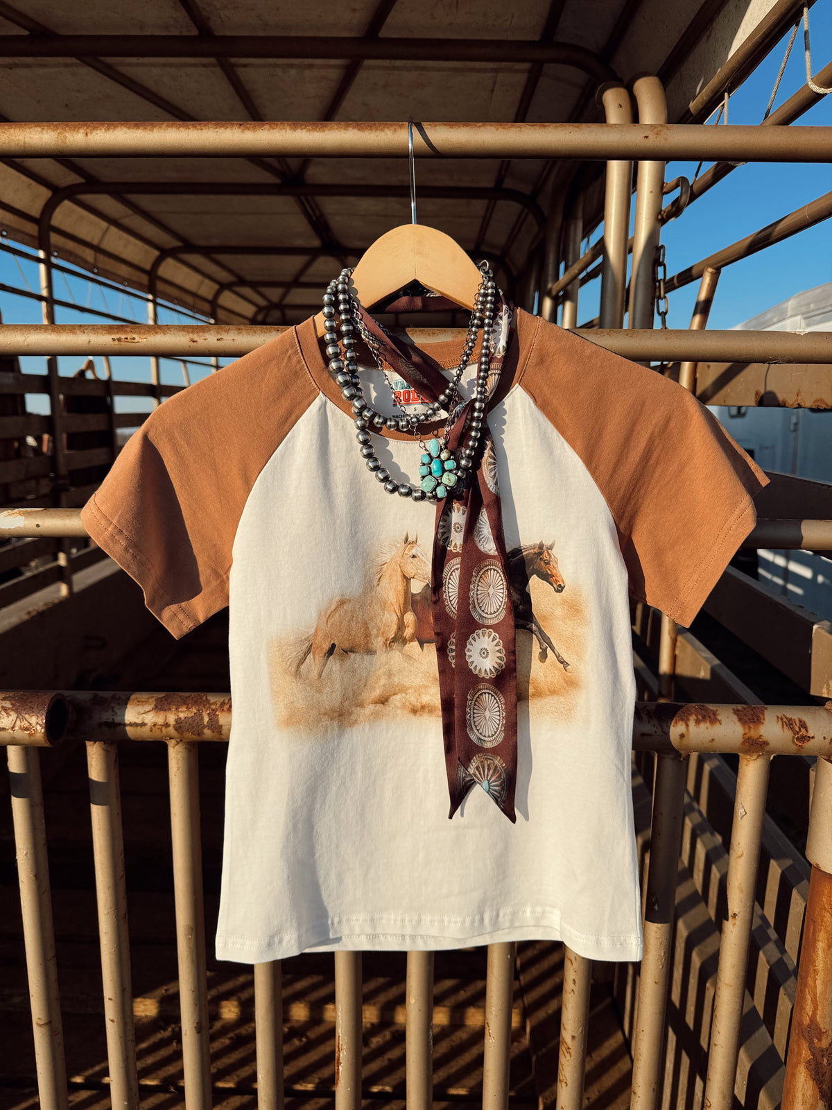 Western Vogue Boutique The Stampede Horses T-Shirt, casual top featuring a horse stampede graphic on soft fabric.
