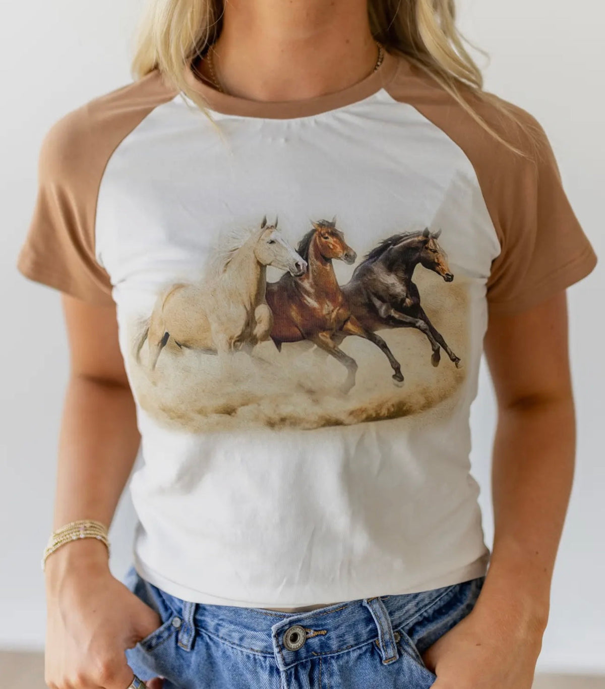 Western Vogue Boutique The Stampede Horses T-Shirt, casual top featuring a Western horse design on soft fabric.