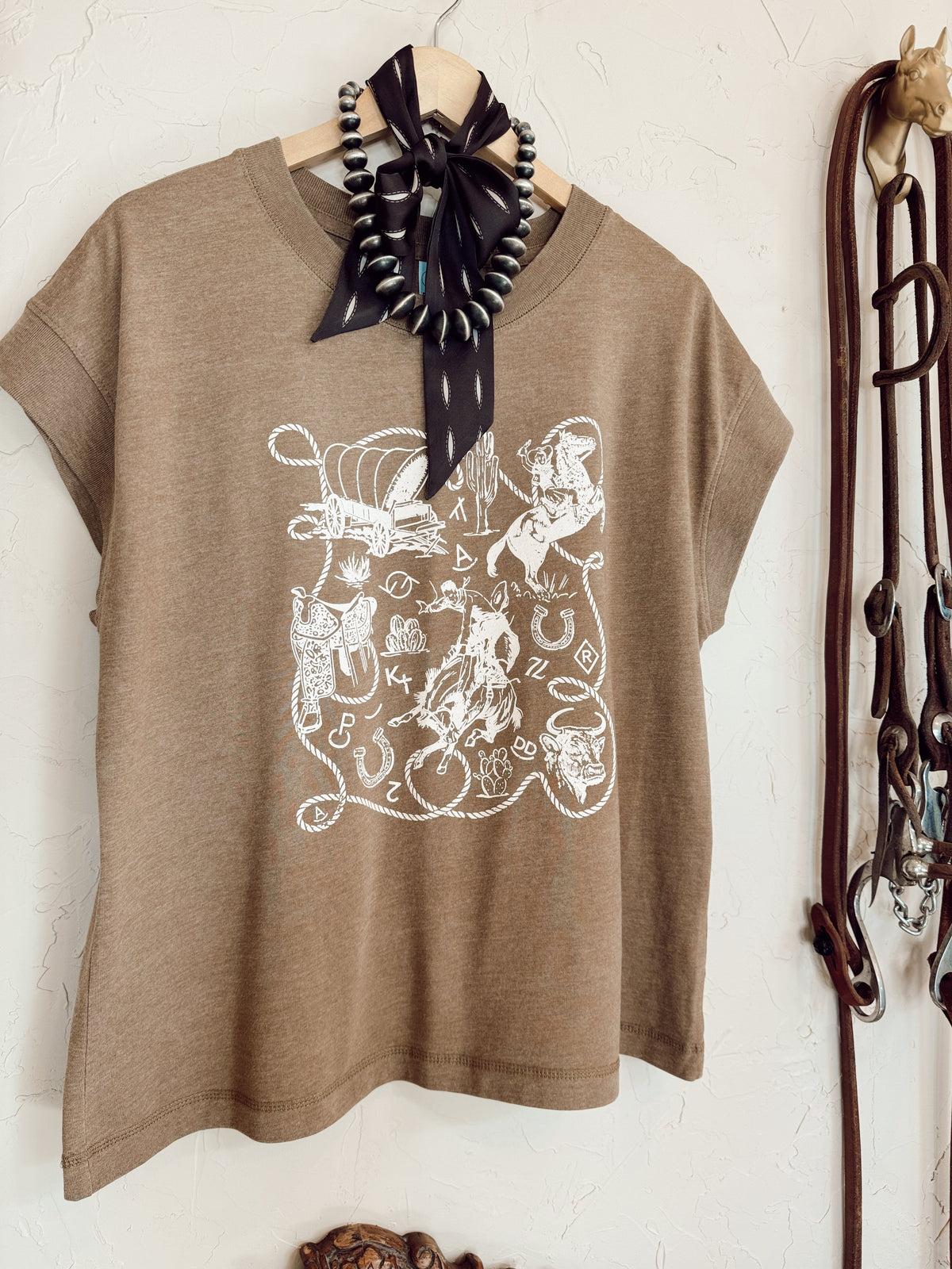 Western Vogue Boutique Western Icons T-Shirt featuring a stylish western-themed graphic on a casual top.