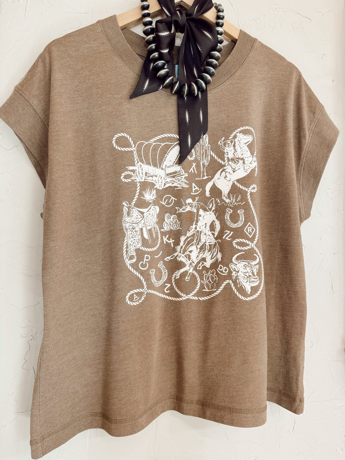 Western Vogue Boutique Western Icons T-Shirt, casual top with Western-inspired graphic design, short sleeves and comfortable fit.