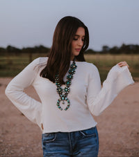 Western Vogue Boutique Bellaire Sweater, soft knit tops in a cozy, stylish design, displayed on a hanger.