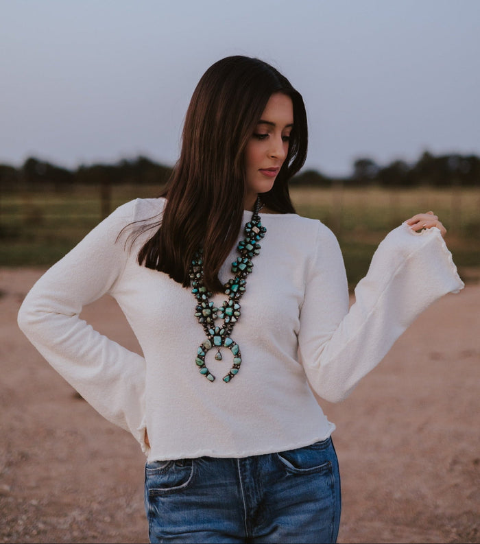Western Vogue Boutique Bellaire Sweater, soft knit tops in a cozy, stylish design, displayed on a hanger.
