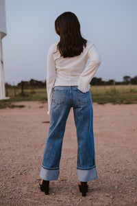 Western Vogue Boutique Bellaire Sweater, stylish long-sleeve tops in soft knit fabric, shown on a hanger.