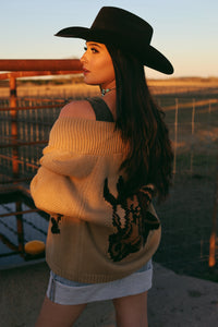 Western Vogue Boutique Opia Top Bodysuit, close-up of stylish black fitted bodysuit with neckline and shoulder details.