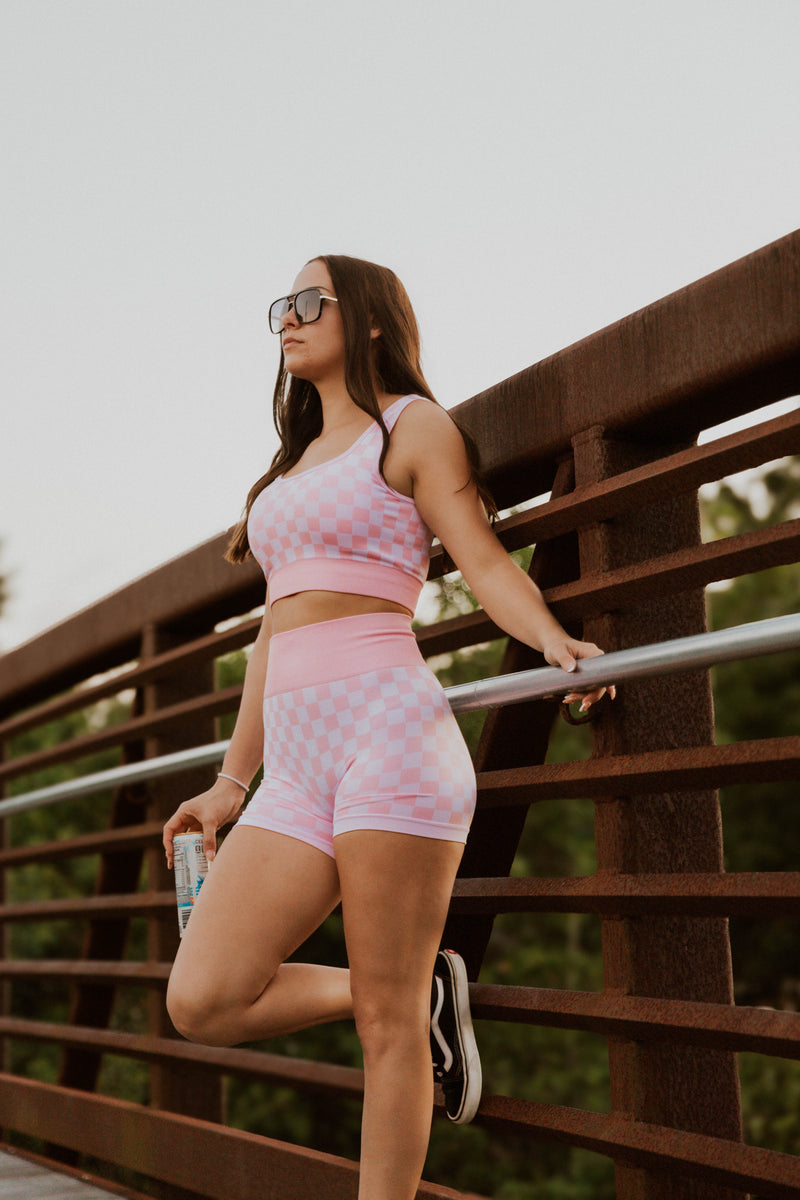 Peach and beige checkered women's gym set from Wild Cactus Boutique, activewear with matching top and leggings.
