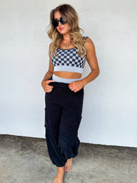 Checkered women's gym set by Wild Cactus Boutique featuring peachy beige and white activewear for workouts and active leisure.