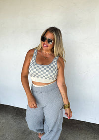 Peach and beige checkered women's gym set by Wild Cactus Boutique, activewear with matching top and leggings for workout.