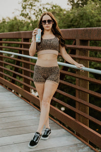Leopard print women's gym set from Wild Cactus Boutique, activewear with matching sports bra and leggings, on a white background.