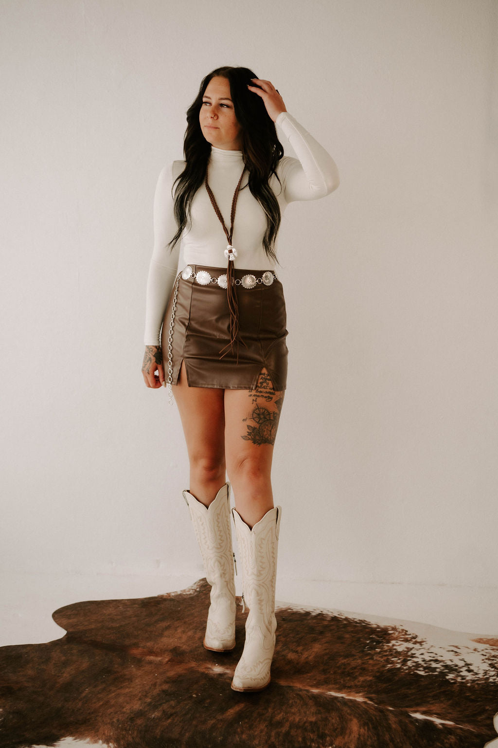 Wild Cactus Boutique Rae's knit bodysuit featuring long sleeves and a fitted design, shown on a model.