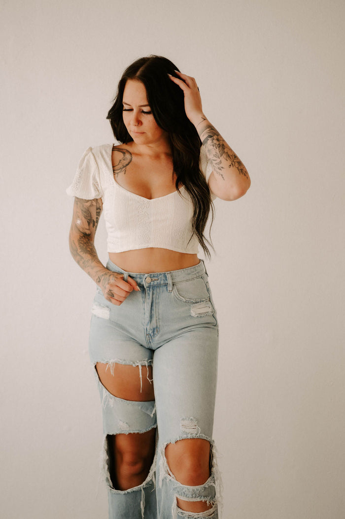 Wild Cactus Boutique smocked crop top featuring a fitted design and adjustable straps, shown in a stylish, casual setting.