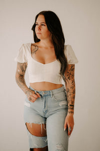 Wild Cactus Boutique smocked crop top featuring ruffled straps and a fitted, stylish design for warm weather.