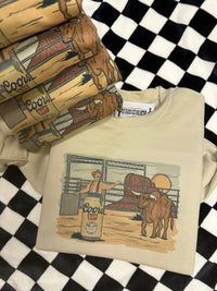 Wild Cactus Boutique Rodeo Scene Western graphic top featuring a colorful cowboy and rodeo imagery on a casual T-shirt.