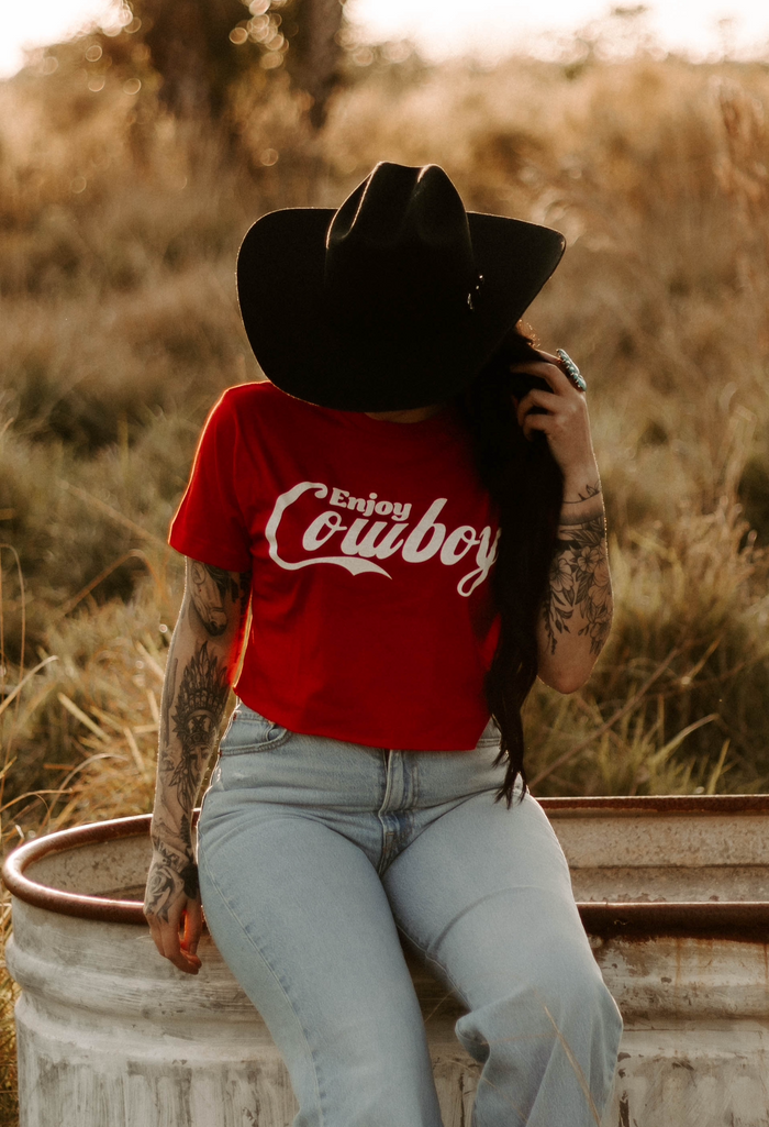 Women's graphic cowboy crop top from Wild Cactus Boutique, featuring western-inspired design and stylish fit.