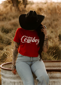 Women's graphic cowboy crop top from Wild Cactus Boutique featuring Western-style design and vibrant print.