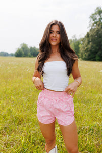 Pink women's camo shorts from Wild Cactus Boutique, casual fit with camouflage pattern, lightweight and comfortable for warm weather.