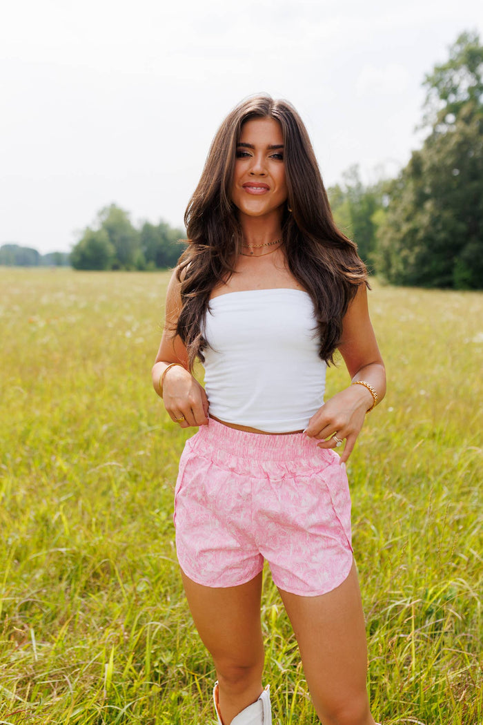 Pink women's camo shorts from Wild Cactus Boutique, casual fit with camouflage pattern, lightweight and comfortable for warm weather.