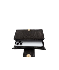 Black Rita Mini clutch by Ximena Kavalekas, showcasing its compact design and elegant style on a neutral background.