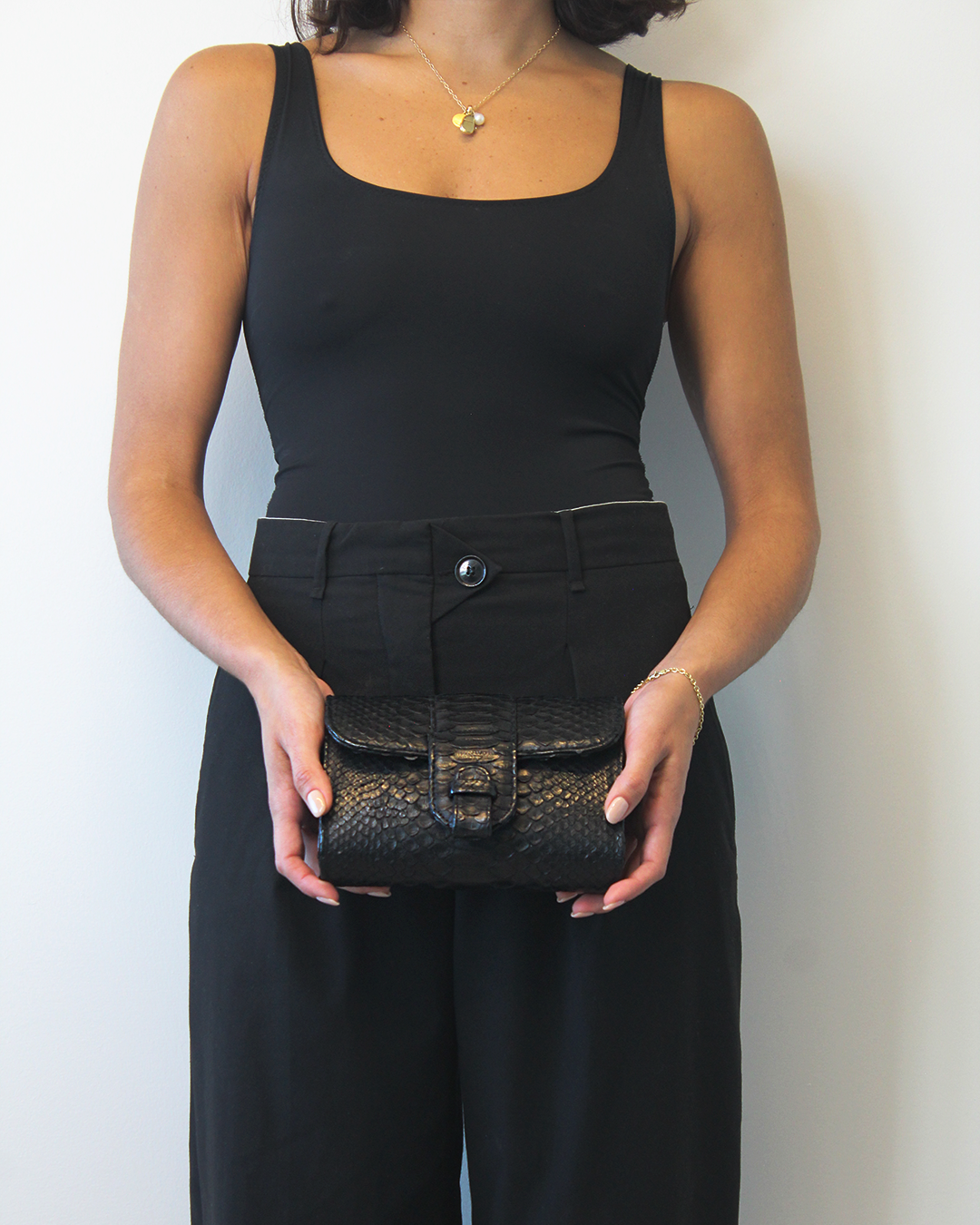 Ximena Kavalekas Rita Mini clutch in black featuring a sleek, compact design with a fashionable chain strap.