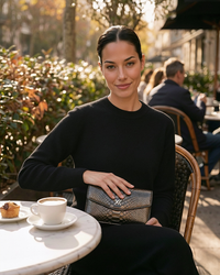 Ximena Kavalekas The Met clutch in gunmetal with sleek design and metallic finish, shown in dark color.