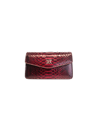 Ximena Kavalekas The Met clutch in midnight red with sleek design and elegant leather finish, shown in a close-up image.