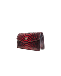 Ximena Kavalekas The Met clutch in vibrant midnight red, stylish leather accessory with sleek design and gold-tone clasp.