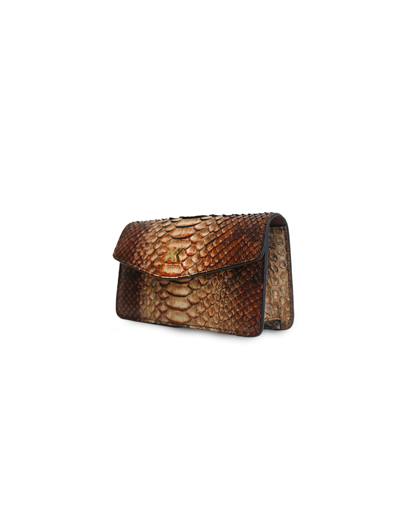 Ximena Kavalekas The Met Clutch in Sunrise showing vibrant orange and yellow sunset-inspired design with sleek leather texture.