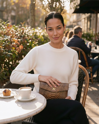 Ximena Kavalekas The Met Clutch in Sunrise with vibrant orange and yellow hues, featuring a sleek, stylish design for evening accessories.