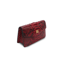 Ximena Kavalekas The Met Clutch in wine color, elegant accessory with a sleek design and textured surface.