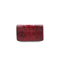 Ximena Kavalekas The Met Clutch in rich wine color, stylish leather clutch bag with sleek design and gold-tone clasp.