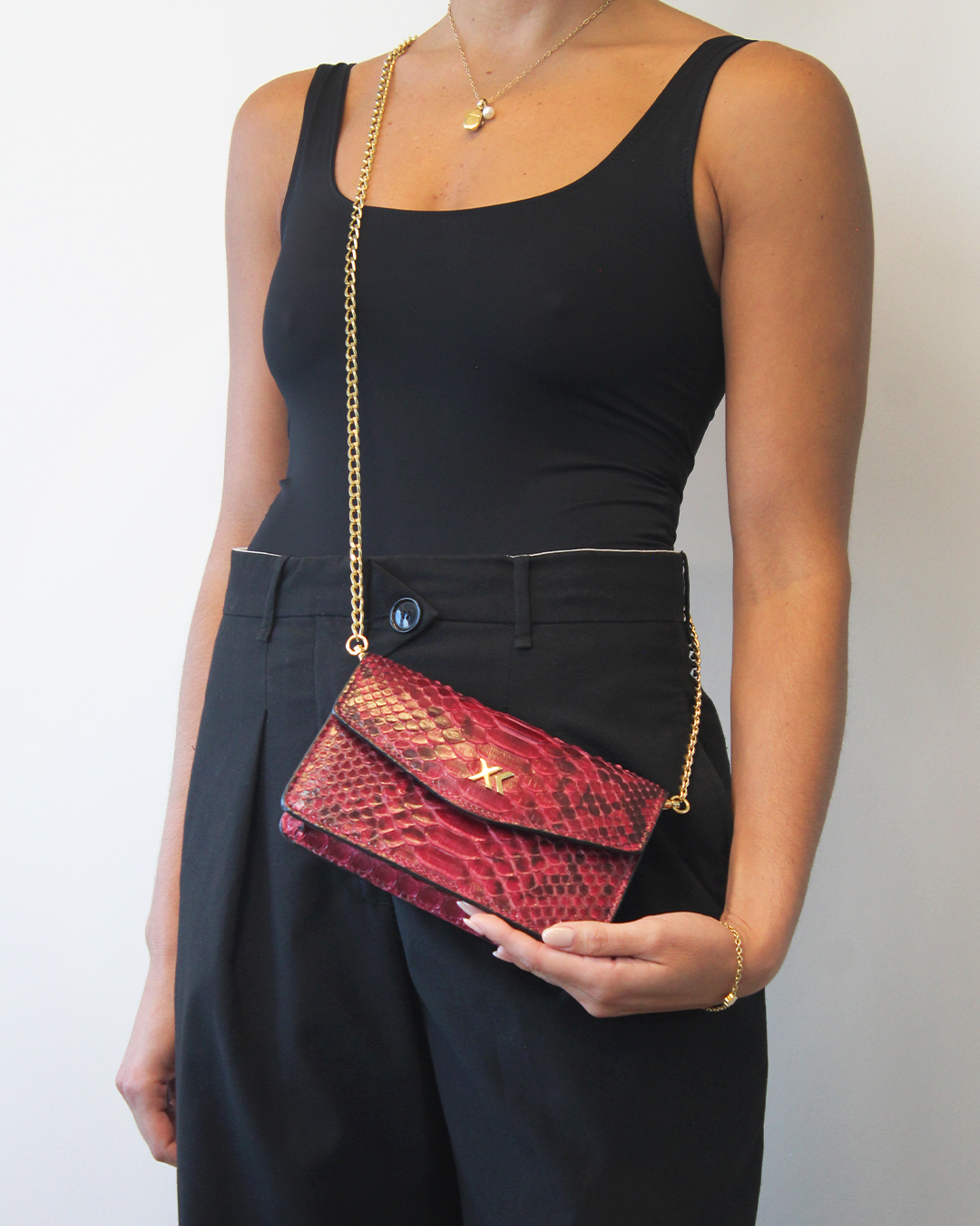 Ximena Kavalekas The Met Clutch in wine color, sleek designer clutch bag with a smooth finish and elegant shape.
