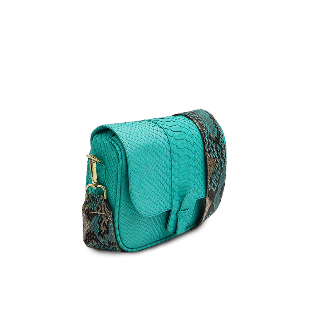 Ximena Kavalekas turquoise crossbody bag named Kara, shown from a three-quarter view highlighting its design and color.