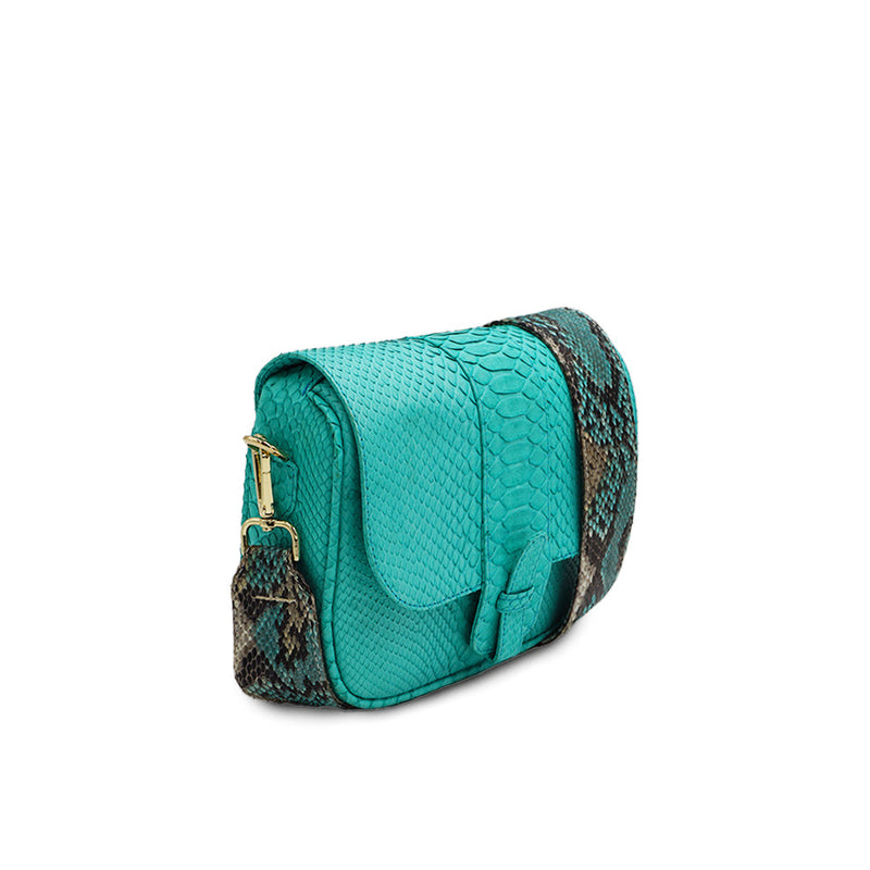 Ximena Kavalekas turquoise crossbody bag named Kara, shown from a three-quarter view highlighting its design and color.