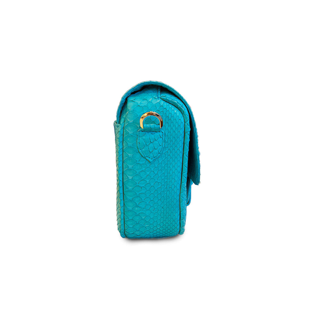 Turquoise Ximena Kavalekas Kara crossbody bag with side view, featuring sleek design and adjustable strap.