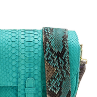 Ximena Kavalekas turquoise crossbody bag named Kara with detailed view showing textured material and sleek design.