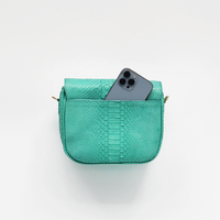Ximena Kavalekas turquoise crossbody bag named Kara, featuring a sleek design and vibrant color.