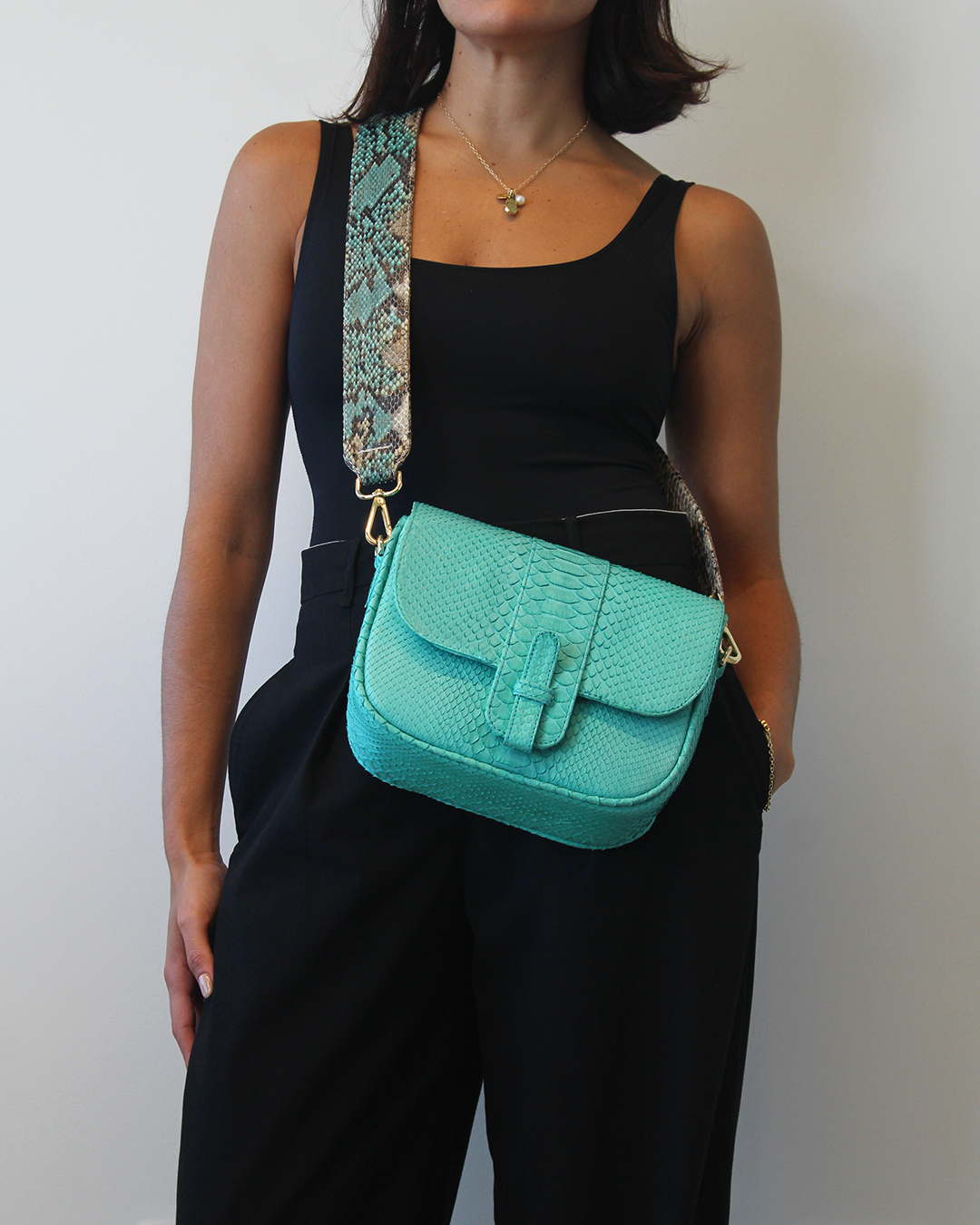 Ximena Kavalekas Kara turquoise crossbody bag with adjustable strap and minimalist design.