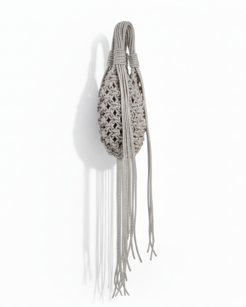 Silver chandelier handbag by Ximena Kavalekas with intricate beaded details and a stylish, elegant shape.